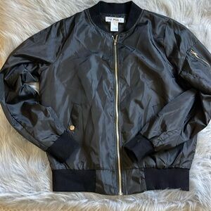 Small black polyester jacket. Great condition